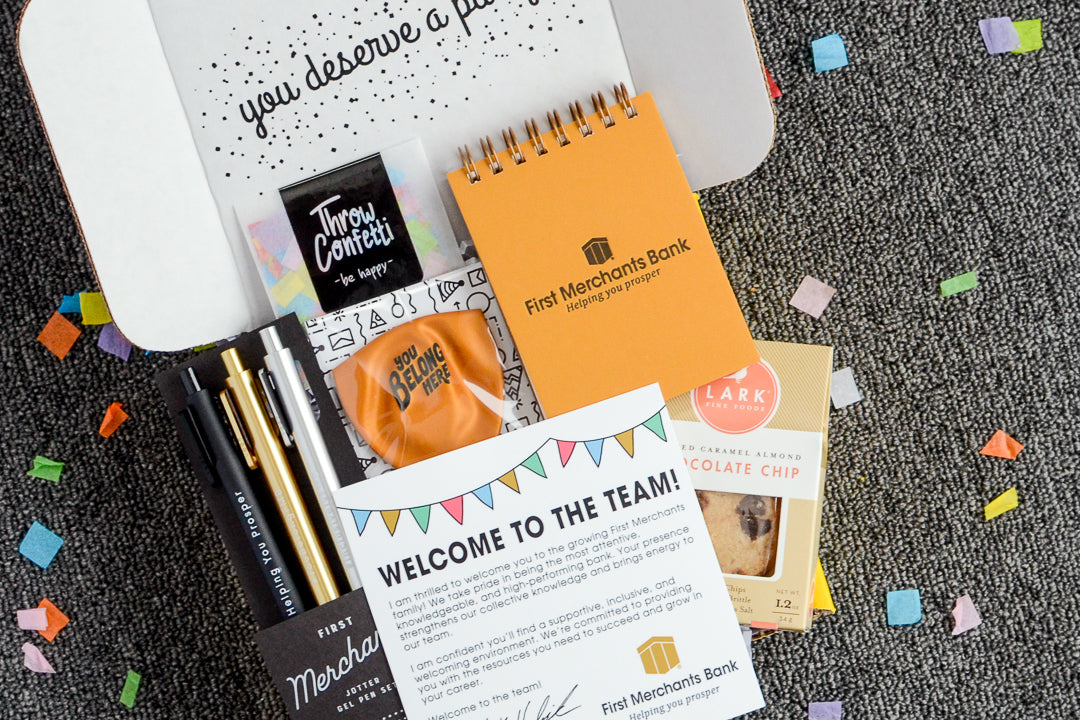 Custom Budget Friendly New Hire Gift Box filled with First Merchants Gold notebook and other custom gift items to match the brand.
