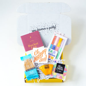 Small affordable graduation gift box filled with pens, notebook, cookies, confetti , balloon and card full box