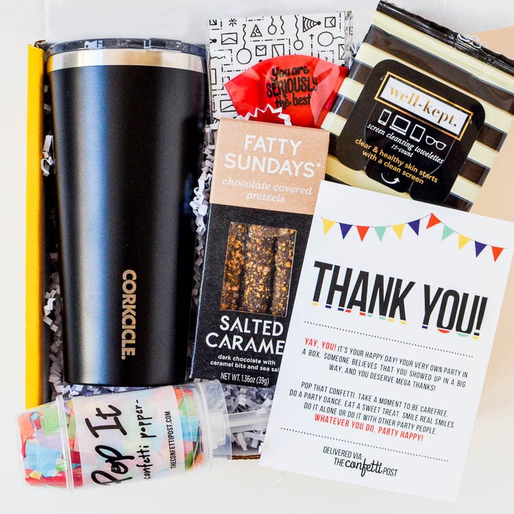 Thank you gift box with black, white, and gold gifts